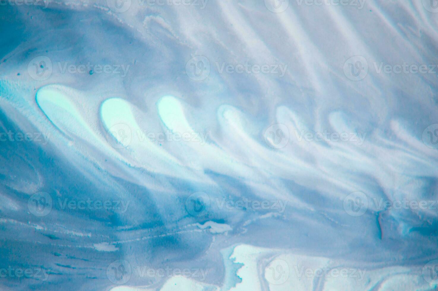 Abstract created using the technique of liquid acrylic. Macro photography of the smallest details of a panting. The panting shows how overflows of shades and colors of paint resemble space motifs. photo