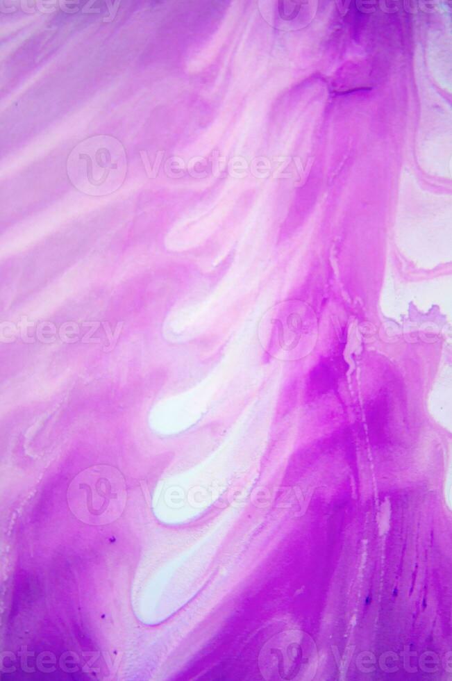 Abstract created using the technique of liquid acrylic. Macro photography of the smallest details of a panting. The panting shows how overflows of shades and colors of paint resemble space motifs. photo