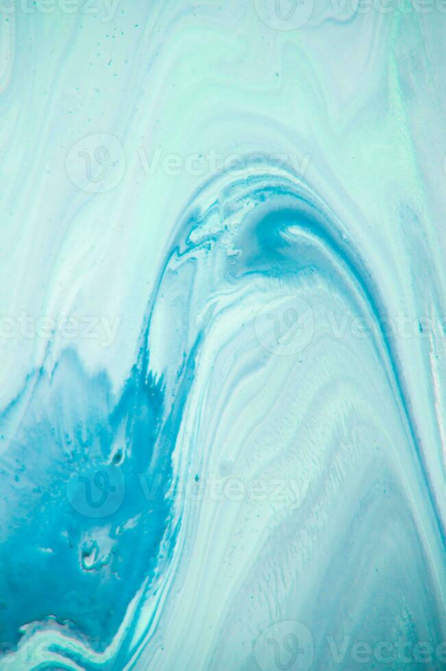 Abstract created using the technique of liquid acrylic. Macro photography of the smallest details of a panting. The panting shows how overflows of shades and colors of paint resemble space motifs. photo