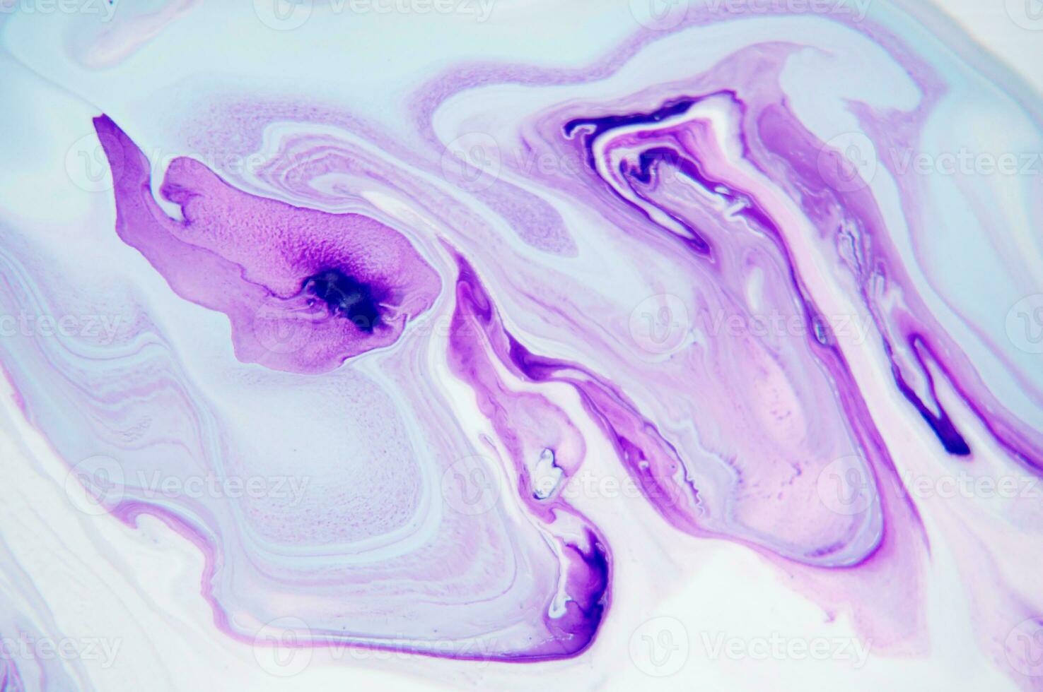 Abstract created using the technique of liquid acrylic. Macro photography of the smallest details of a panting. The panting shows how overflows of shades and colors of paint resemble space motifs. photo