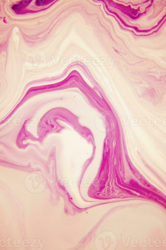 Abstract created using the technique of liquid acrylic. Macro photography of the smallest details of a panting. The panting shows how overflows of shades and colors of paint resemble space motifs. photo