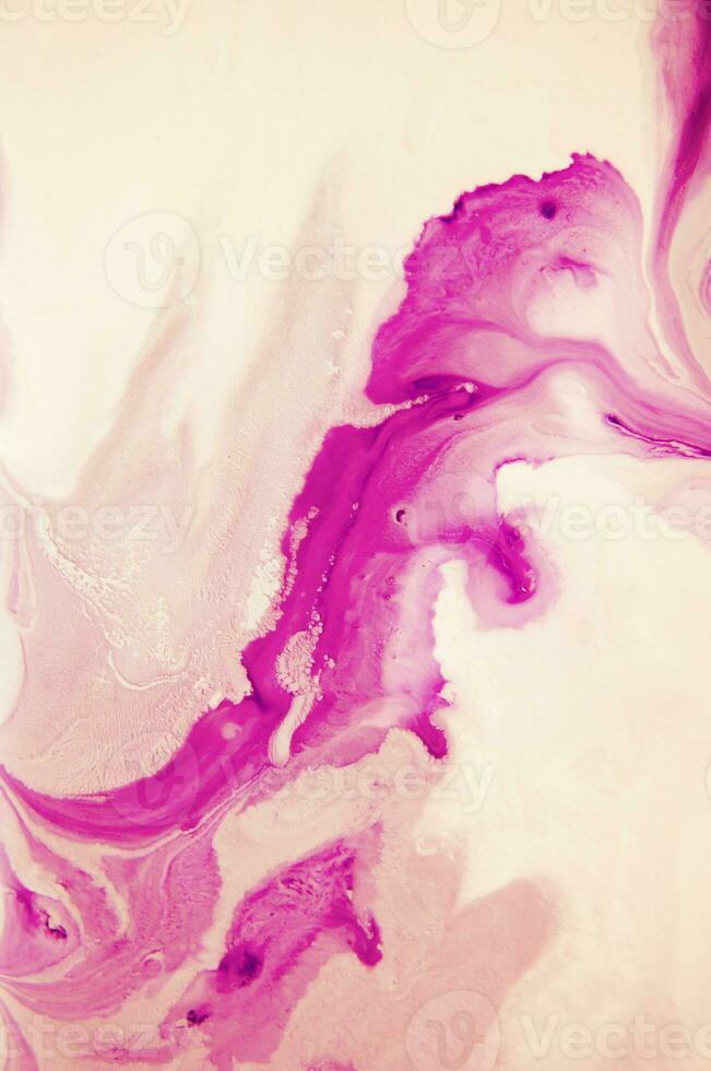 Abstract created using the technique of liquid acrylic. Macro photography of the smallest details of a panting. The panting shows how overflows of shades and colors of paint resemble space motifs. photo