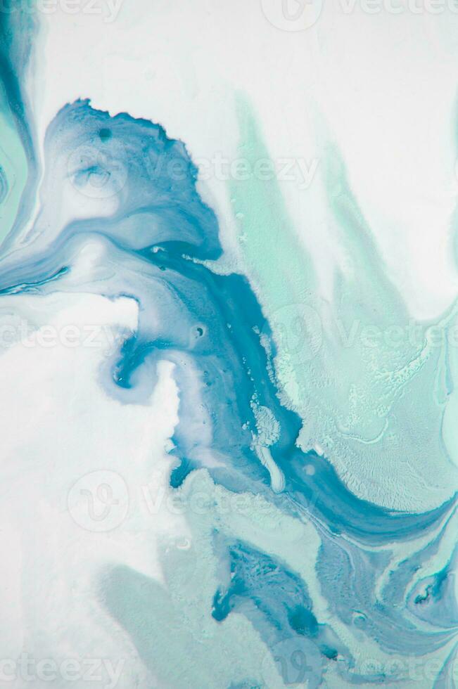 Abstract created using the technique of liquid acrylic. Macro photography of the smallest details of a panting. The panting shows how overflows of shades and colors of paint resemble space motifs. photo