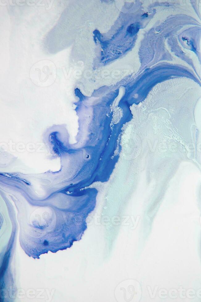 Abstract created using the technique of liquid acrylic. Macro photography of the smallest details of a panting. The panting shows how overflows of shades and colors of paint resemble space motifs. photo