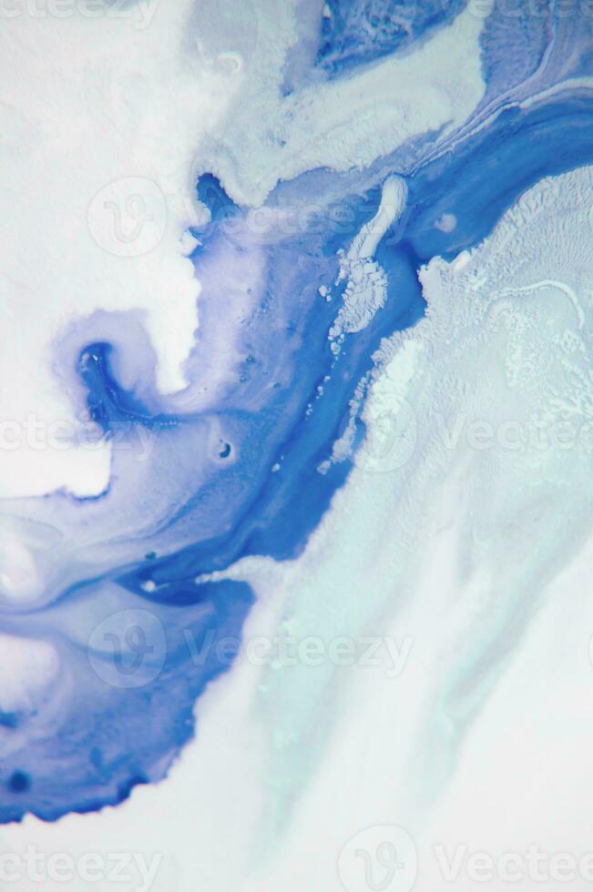 Abstract created using the technique of liquid acrylic. Macro photography of the smallest details of a panting. The panting shows how overflows of shades and colors of paint resemble space motifs. photo