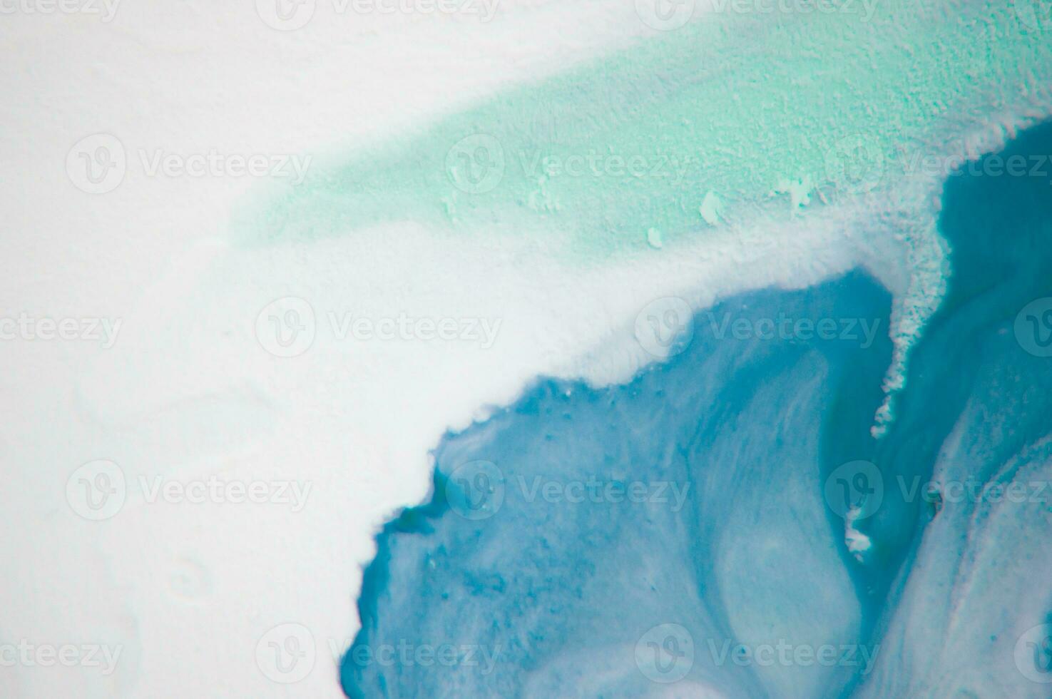 Abstract created using the technique of liquid acrylic. Macro photography of the smallest details of a panting. The panting shows how overflows of shades and colors of paint resemble space motifs. photo
