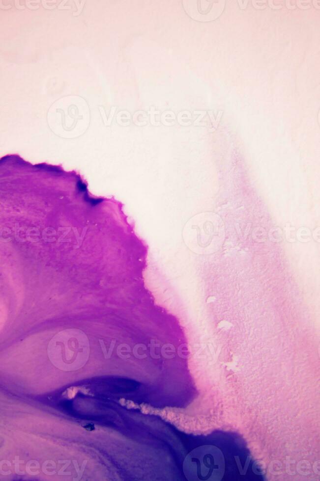 Abstract created using the technique of liquid acrylic. Macro photography of the smallest details of a panting. The panting shows how overflows of shades and colors of paint resemble space motifs. photo