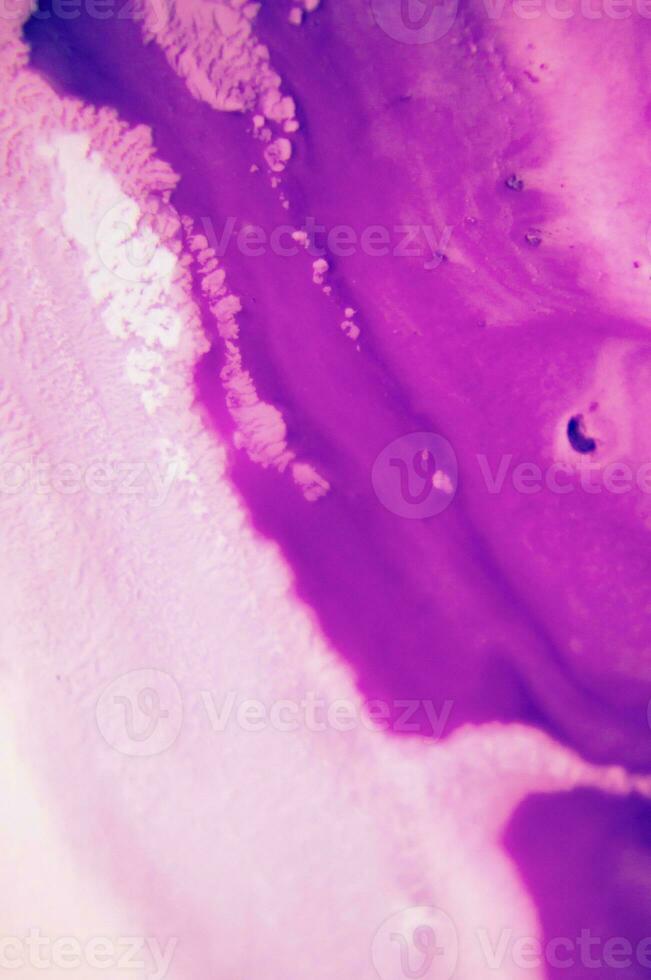 Abstract created using the technique of liquid acrylic. Macro photography of the smallest details of a panting. The panting shows how overflows of shades and colors of paint resemble space motifs. photo
