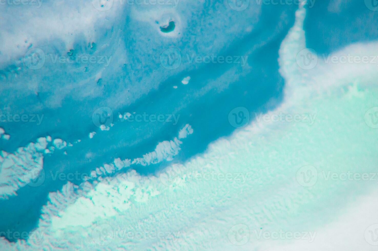 Abstract created using the technique of liquid acrylic. Macro photography of the smallest details of a panting. The panting shows how overflows of shades and colors of paint resemble space motifs. photo