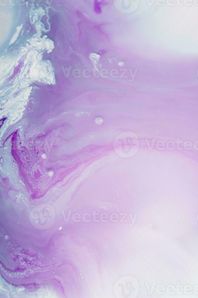 Abstract created using the technique of liquid acrylic. Macro photography of the smallest details of a panting. The panting shows how overflows of shades and colors of paint resemble space motifs. photo