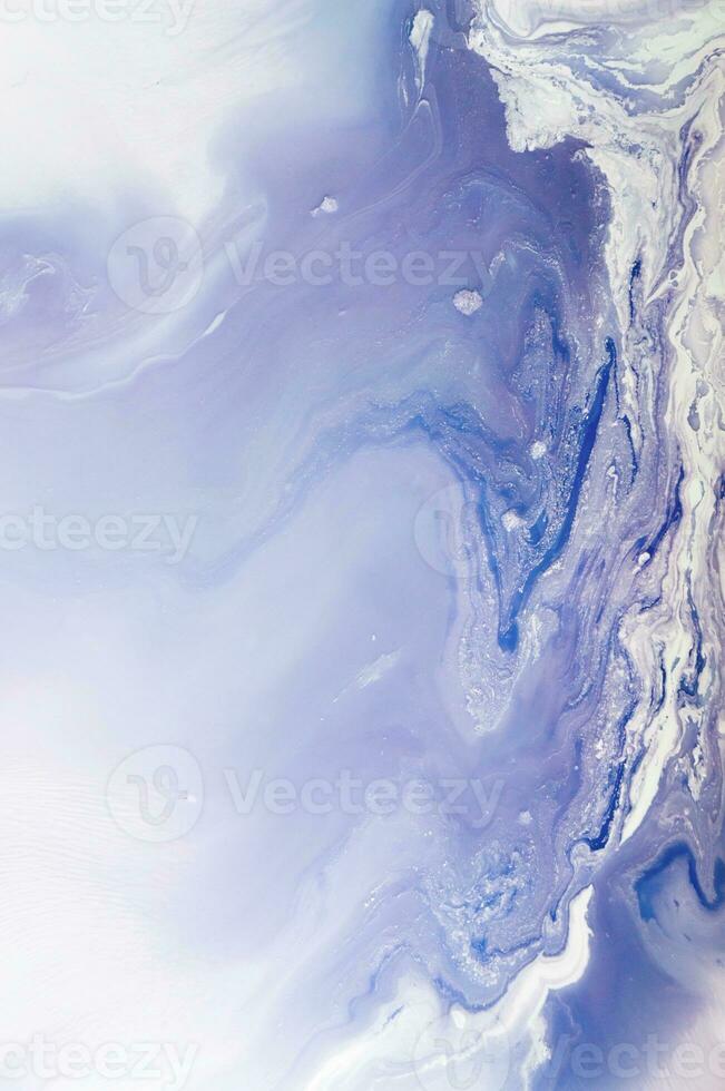 Abstract created using the technique of liquid acrylic. Macro photography of the smallest details of a panting. The panting shows how overflows of shades and colors of paint resemble space motifs. photo