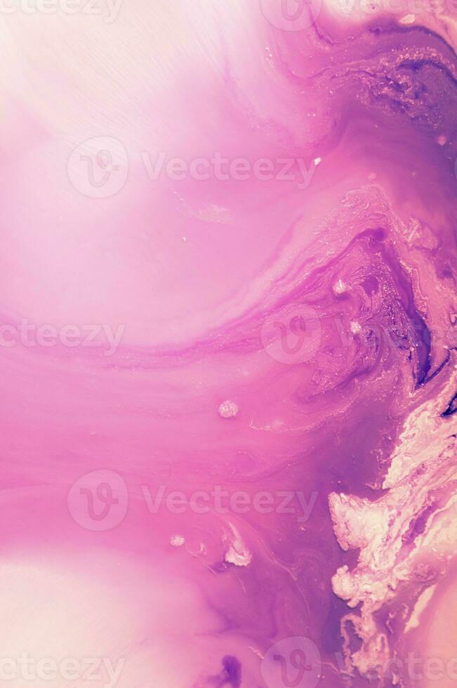 Abstract created using the technique of liquid acrylic. Macro photography of the smallest details of a panting. The panting shows how overflows of shades and colors of paint resemble space motifs. photo