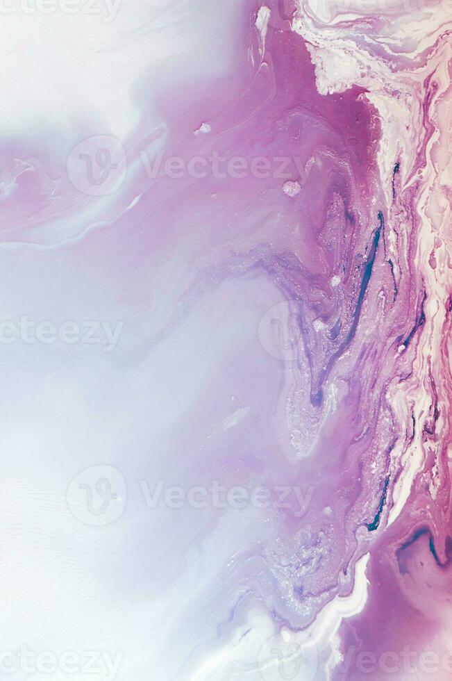 Abstract created using the technique of liquid acrylic. Macro photography of the smallest details of a panting. The panting shows how overflows of shades and colors of paint resemble space motifs. photo