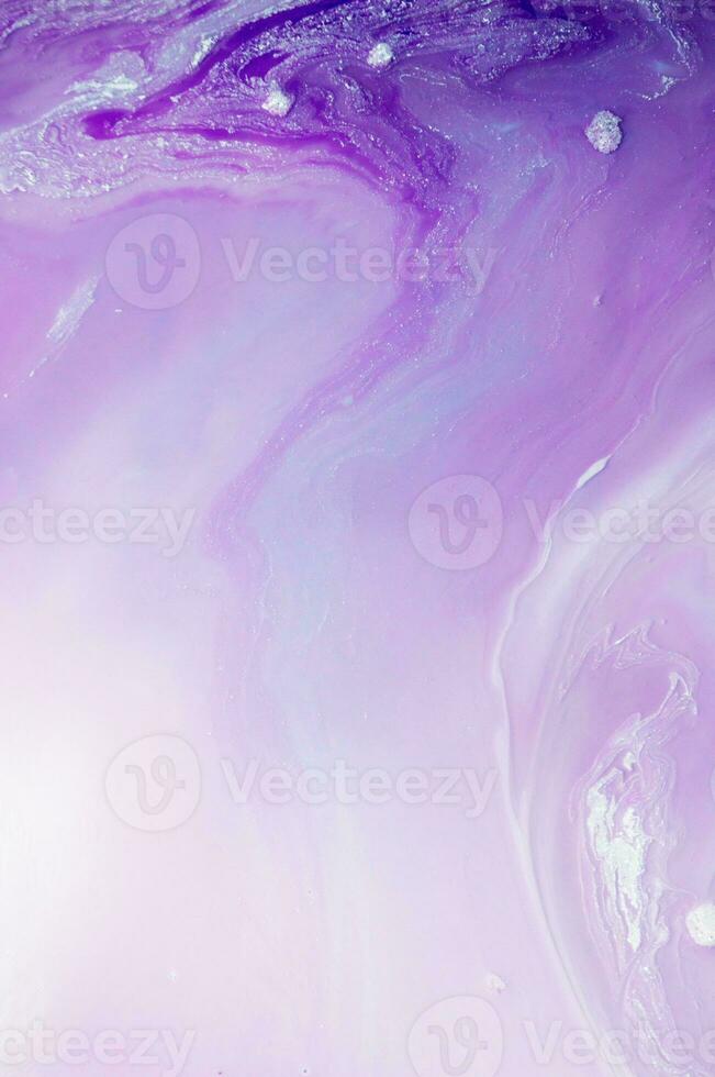 Abstract created using the technique of liquid acrylic. Macro photography of the smallest details of a panting. The panting shows how overflows of shades and colors of paint resemble space motifs. photo