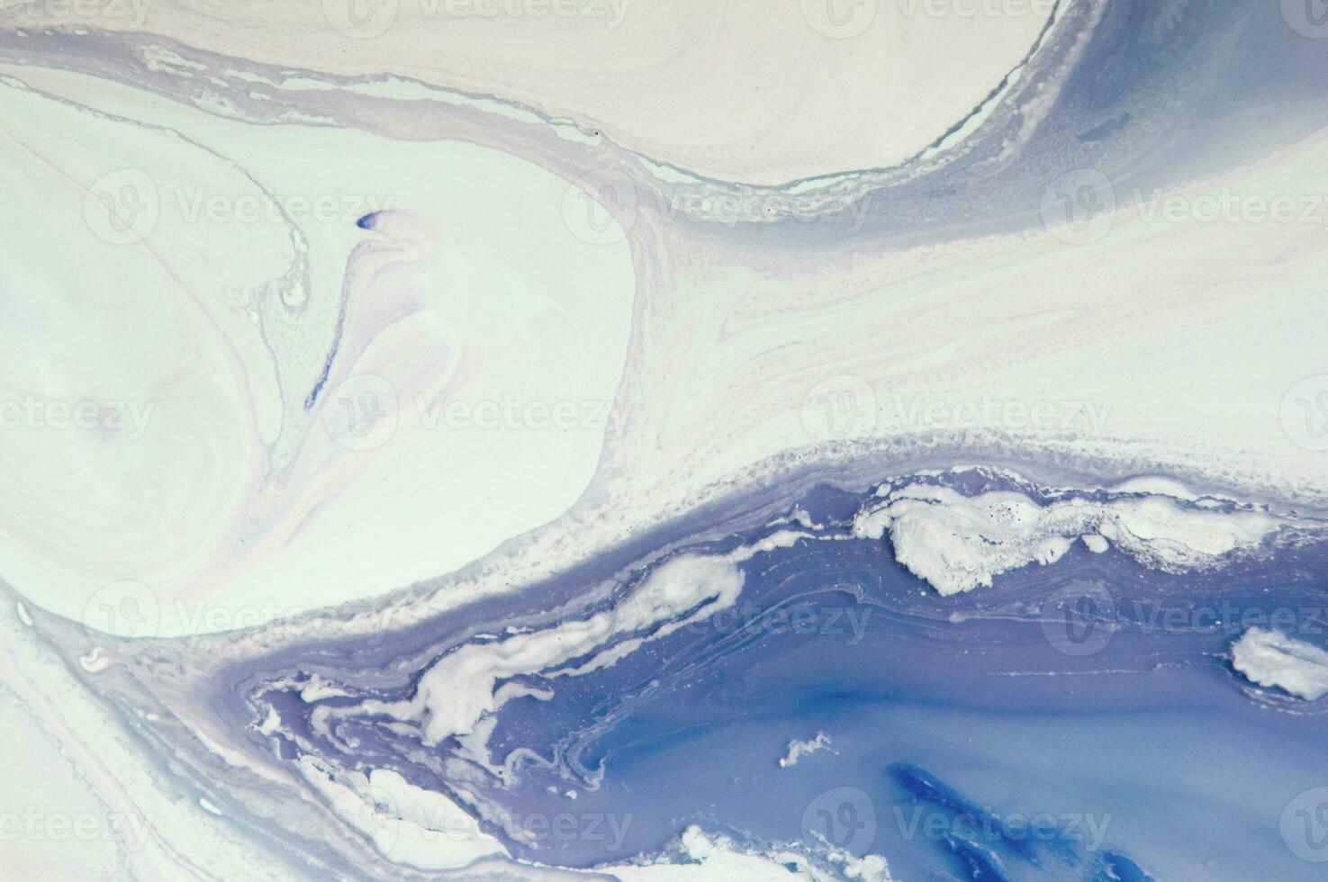 Abstract created using the technique of liquid acrylic. Macro photography of the smallest details of a panting. The panting shows how overflows of shades and colors of paint resemble space motifs. photo