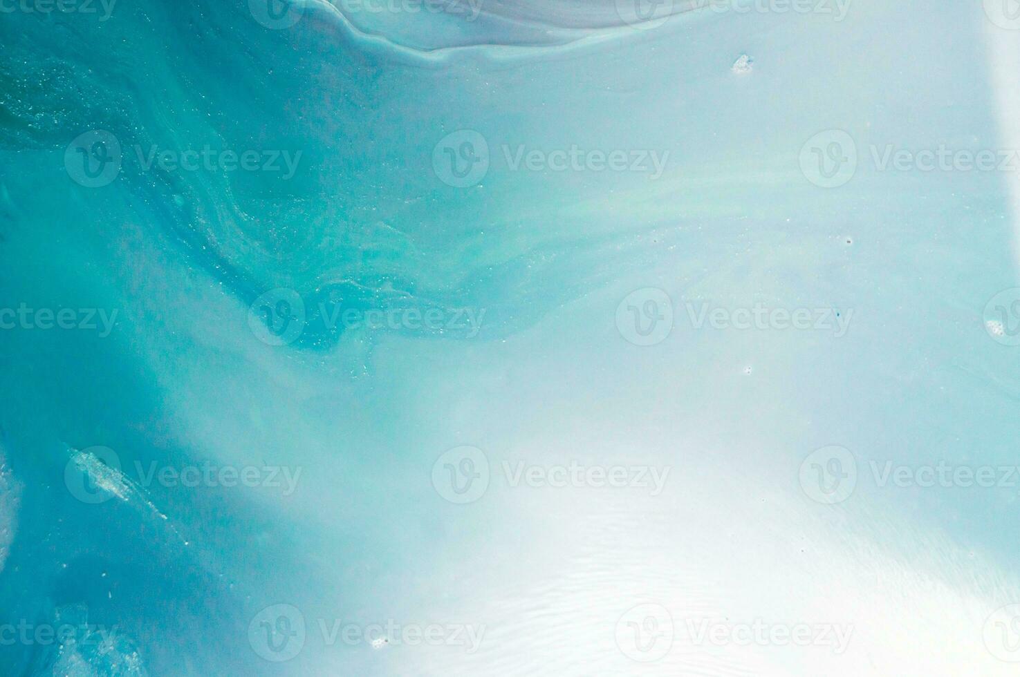 Abstract created using the technique of liquid acrylic. Macro photography of the smallest details of a panting. The panting shows how overflows of shades and colors of paint resemble space motifs. photo