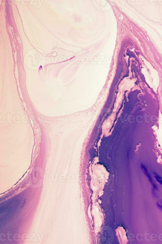 Abstract created using the technique of liquid acrylic. Macro photography of the smallest details of a panting. The panting shows how overflows of shades and colors of paint resemble space motifs. photo