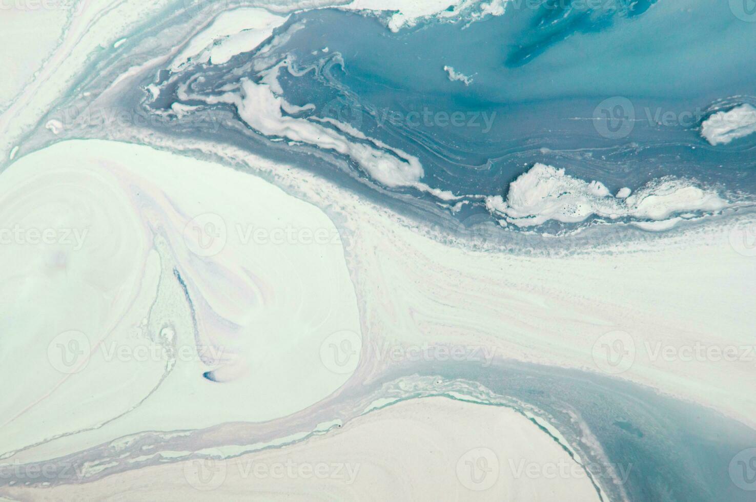 Abstract created using the technique of liquid acrylic. Macro photography of the smallest details of a panting. The panting shows how overflows of shades and colors of paint resemble space motifs. photo