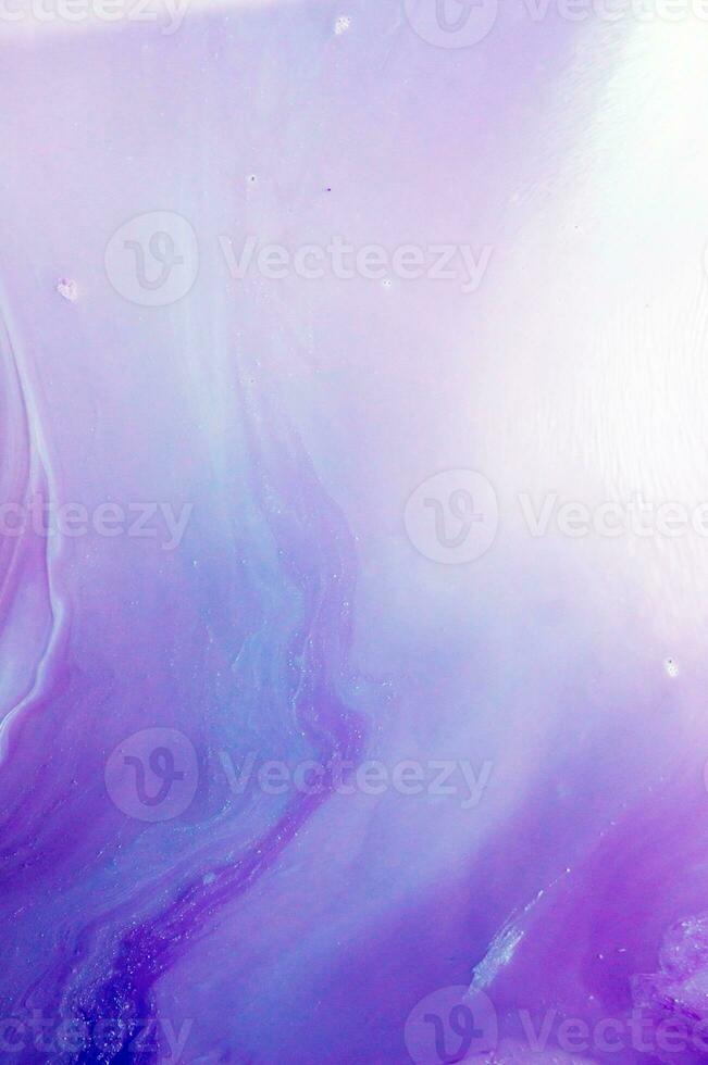 Abstract created using the technique of liquid acrylic. Macro photography of the smallest details of a panting. The panting shows how overflows of shades and colors of paint resemble space motifs. photo