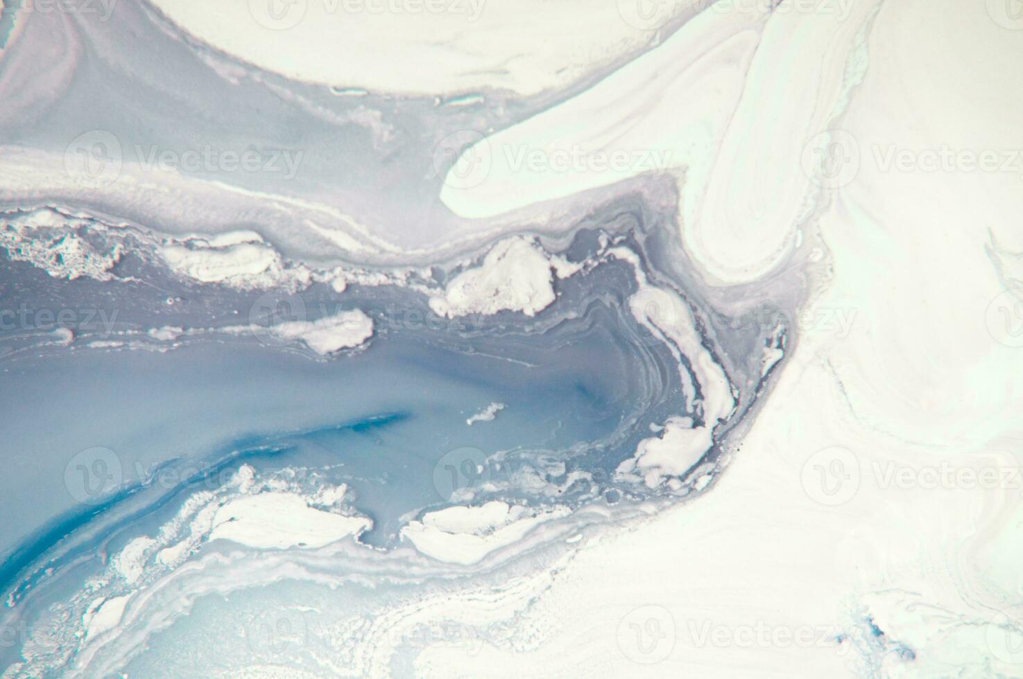 Abstract created using the technique of liquid acrylic. Macro photography of the smallest details of a panting. The panting shows how overflows of shades and colors of paint resemble space motifs. photo