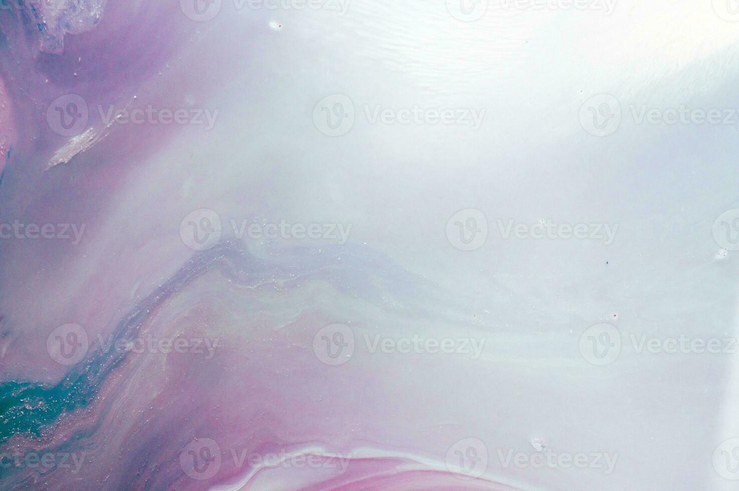 Abstract created using the technique of liquid acrylic. Macro photography of the smallest details of a panting. The panting shows how overflows of shades and colors of paint resemble space motifs. photo