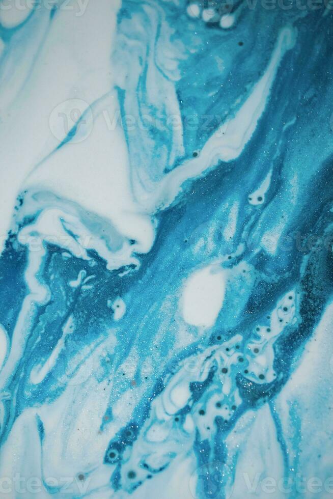Abstract created using the technique of liquid acrylic. Macro photography of the smallest details of a picture. The picture shows how overflows of shades and colors of paint resemble space motifs. photo