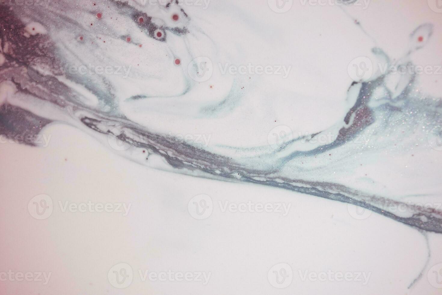 Abstract created using the technique of liquid acrylic. Macro photography of the smallest details of a picture. The picture shows how overflows of shades and colors of paint resemble space motifs. photo