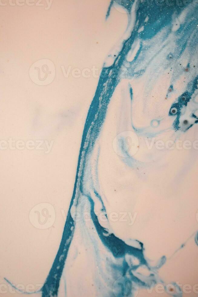 Abstract created using the technique of liquid acrylic. Macro photography of the smallest details of a picture. The picture shows how overflows of shades and colors of paint resemble space motifs. photo