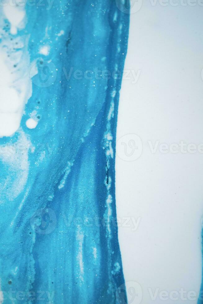 Abstract created using the technique of liquid acrylic. Macro photography of the smallest details of a picture. The picture shows how overflows of shades and colors of paint resemble space motifs. photo