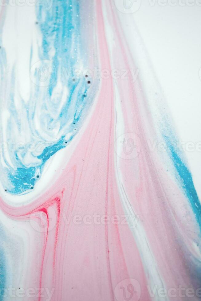 Abstract created using the technique of liquid acrylic. Macro photography of the smallest details of a picture. The picture shows how overflows of shades and colors of paint resemble space motifs. photo