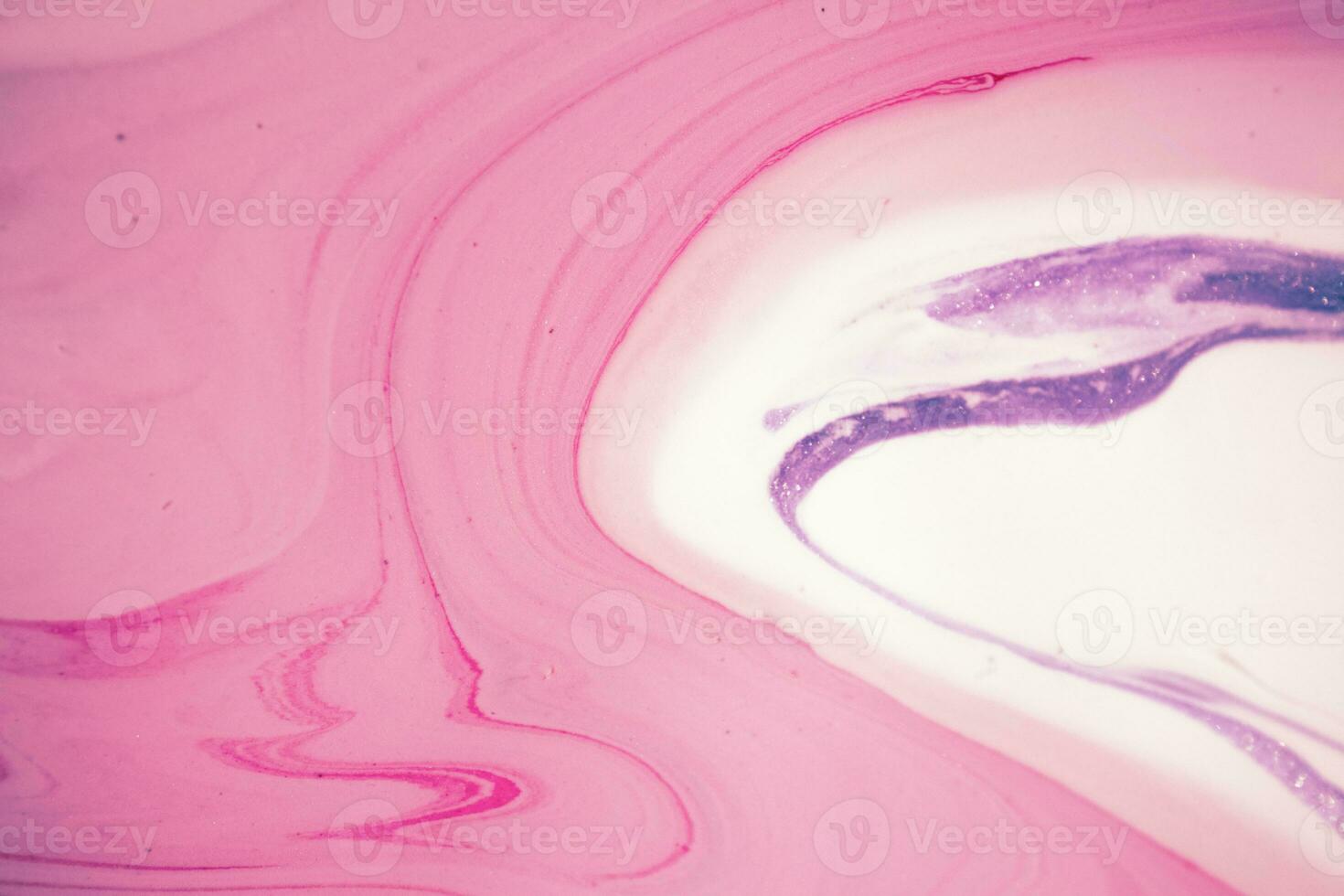 Abstract created using the technique of liquid acrylic. Macro photography of the smallest details of a picture. The picture shows how overflows of shades and colors of paint resemble space motifs. photo