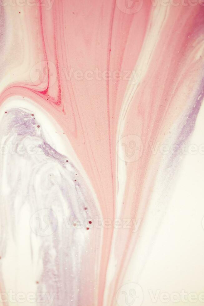Abstract created using the technique of liquid acrylic. Macro photography of the smallest details of a picture. The picture shows how overflows of shades and colors of paint resemble space motifs. photo
