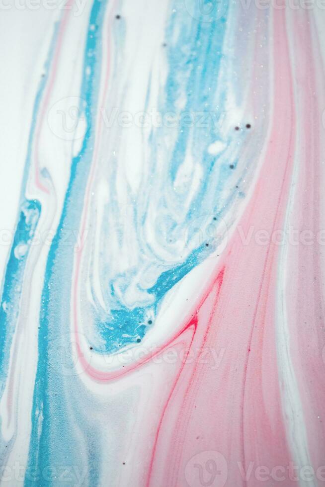 Abstract created using the technique of liquid acrylic. Macro photography of the smallest details of a picture. The picture shows how overflows of shades and colors of paint resemble space motifs. photo