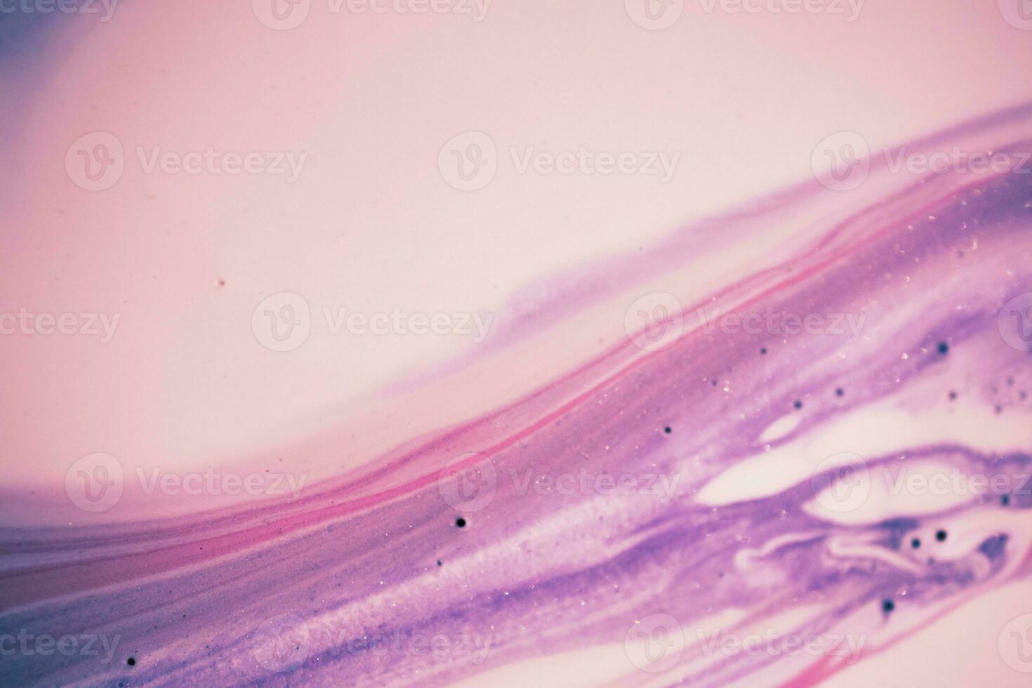 Abstract created using the technique of liquid acrylic. Macro photography of the smallest details of a picture. The picture shows how overflows of shades and colors of paint resemble space motifs. photo