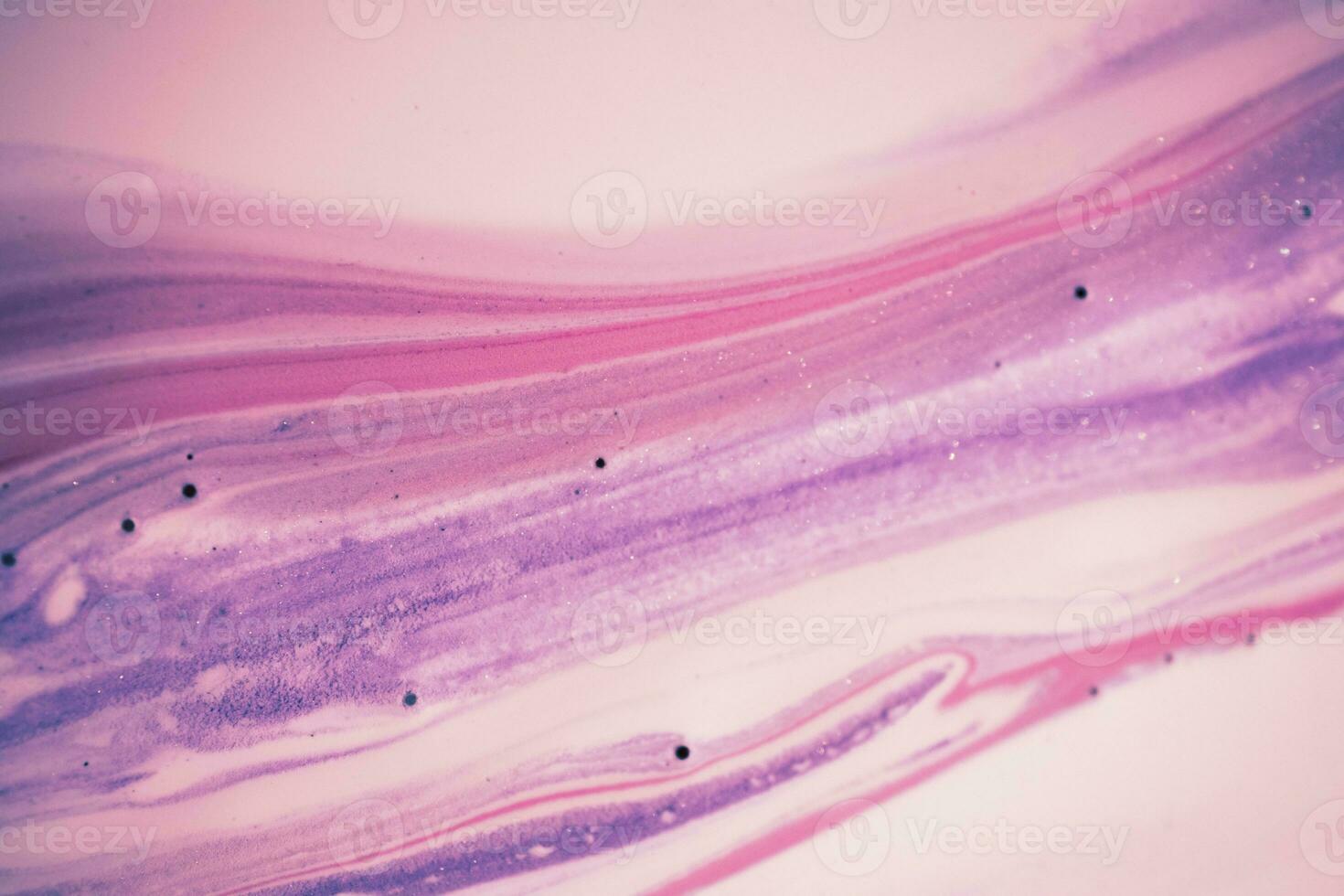 Abstract created using the technique of liquid acrylic. Macro photography of the smallest details of a picture. The picture shows how overflows of shades and colors of paint resemble space motifs. photo