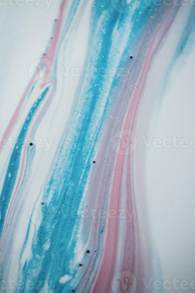 Abstract created using the technique of liquid acrylic. Macro photography of the smallest details of a picture. The picture shows how overflows of shades and colors of paint resemble space motifs. photo