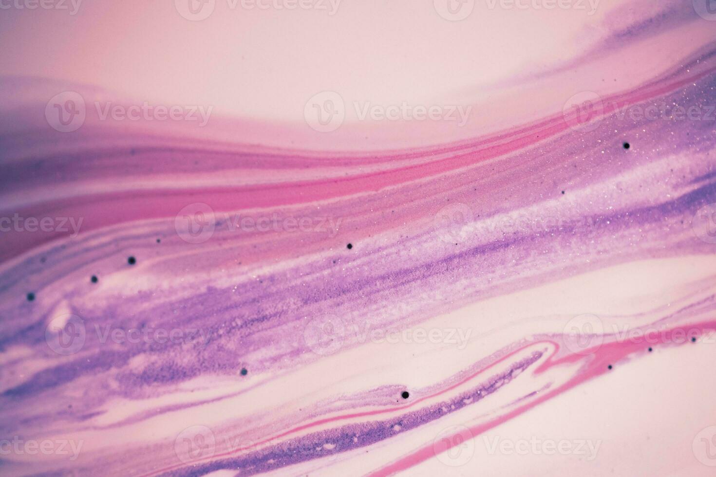 Abstract created using the technique of liquid acrylic. Macro photography of the smallest details of a picture. The picture shows how overflows of shades and colors of paint resemble space motifs. photo