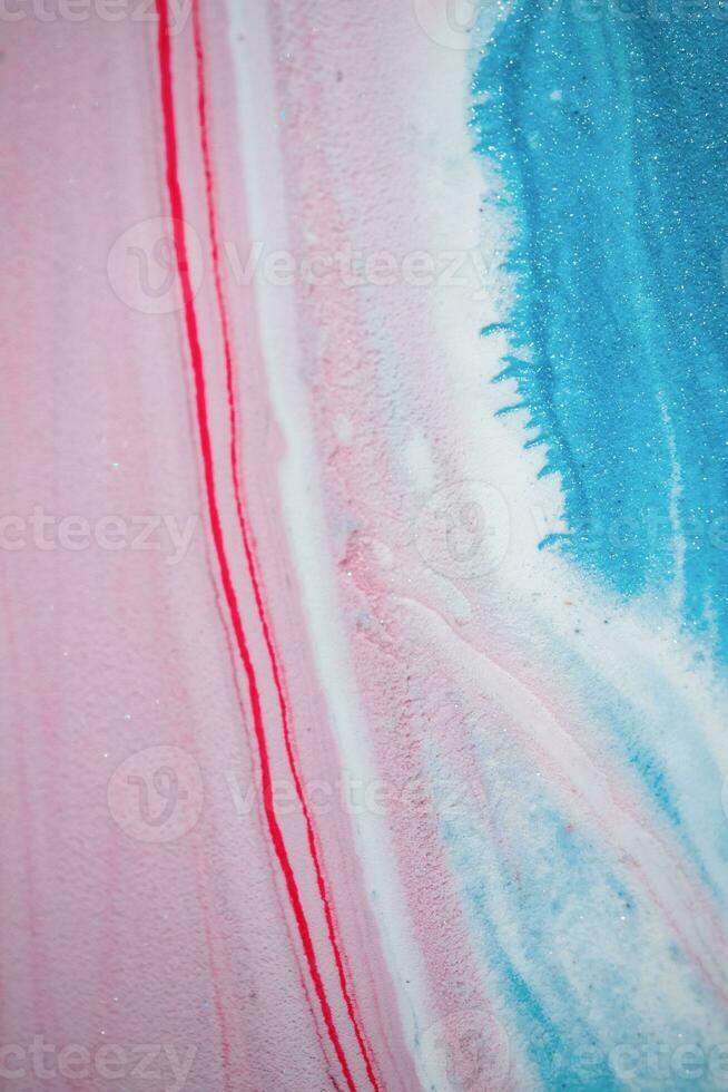 Abstract created using the technique of liquid acrylic. Macro photography of the smallest details of a picture. The picture shows how overflows of shades and colors of paint resemble space motifs. photo