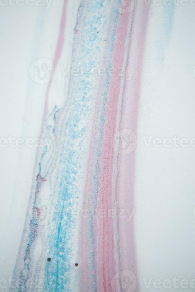 Abstract created using the technique of liquid acrylic. Macro photography of the smallest details of a picture. The picture shows how overflows of shades and colors of paint resemble space motifs. photo