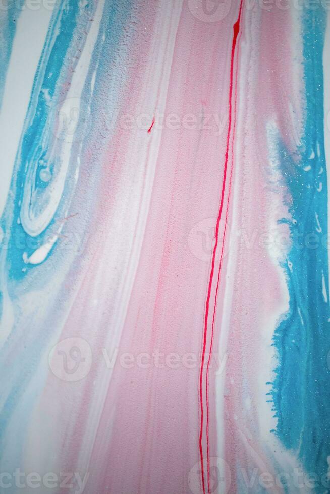 Abstract created using the technique of liquid acrylic. Macro photography of the smallest details of a picture. The picture shows how overflows of shades and colors of paint resemble space motifs. photo