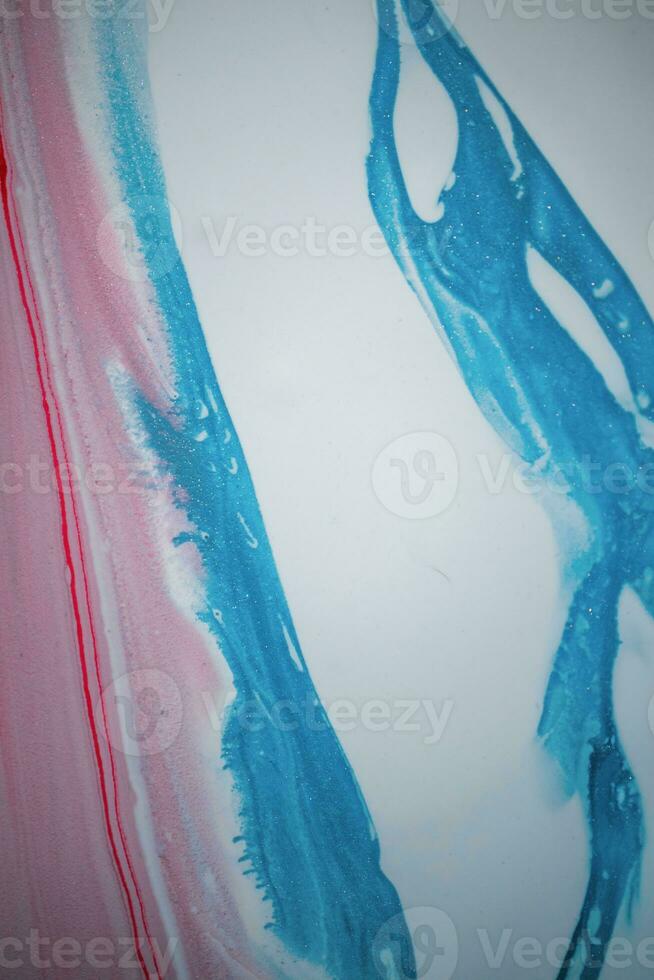 Abstract created using the technique of liquid acrylic. Macro photography of the smallest details of a picture. The picture shows how overflows of shades and colors of paint resemble space motifs. photo