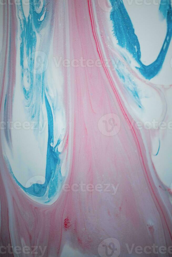 Abstract created using the technique of liquid acrylic. Macro photography of the smallest details of a picture. The picture shows how overflows of shades and colors of paint resemble space motifs. photo