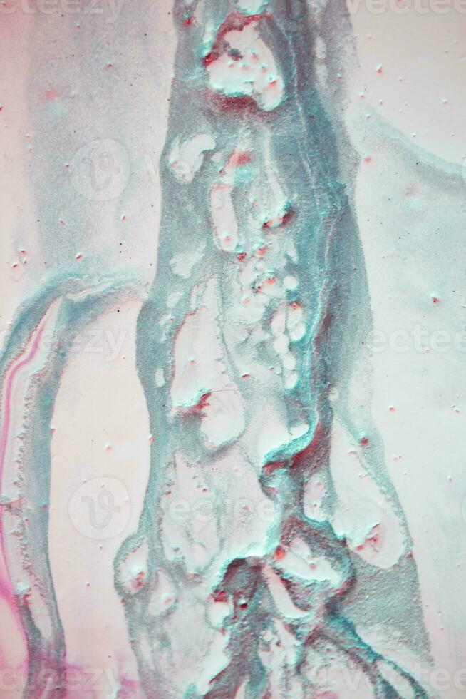 Abstract created using the technique of liquid acrylic. Macro photography of the smallest details of a picture. The picture shows how overflows of shades and colors of paint resemble space motifs. photo