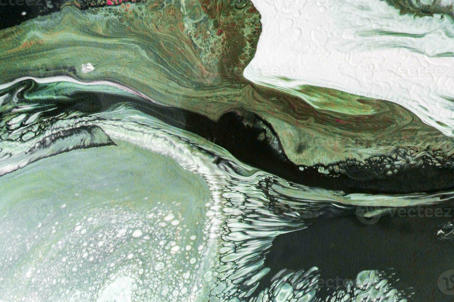 Abstract created using the technique of liquid acrylic. Macro photography of the smallest details of a picture. The picture shows how overflows of shades and colors of paint resemble space motifs. photo