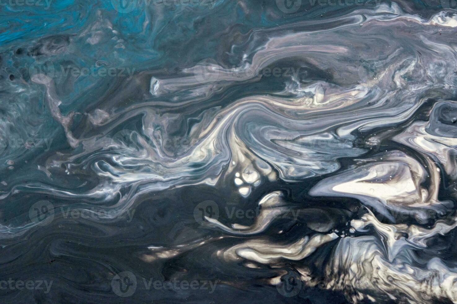 Abstract created using the technique of liquid acrylic. Macro photography of the smallest details of a picture. The picture shows how overflows of shades and colors of paint resemble space motifs. photo