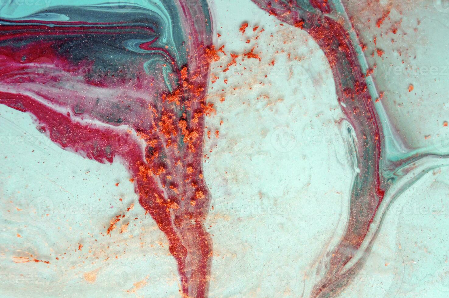 Abstract created using the technique of liquid acrylic. Macro photography of the smallest details of a panting. The panting shows how overflows of shades and colors of paint resemble space motifs. photo