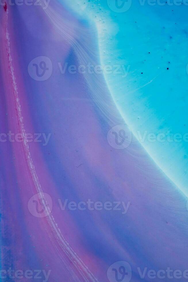 Abstract created using the technique of liquid acrylic. Macro photography of the smallest details of a panting. The panting shows how overflows of shades and colors of paint resemble space motifs. photo