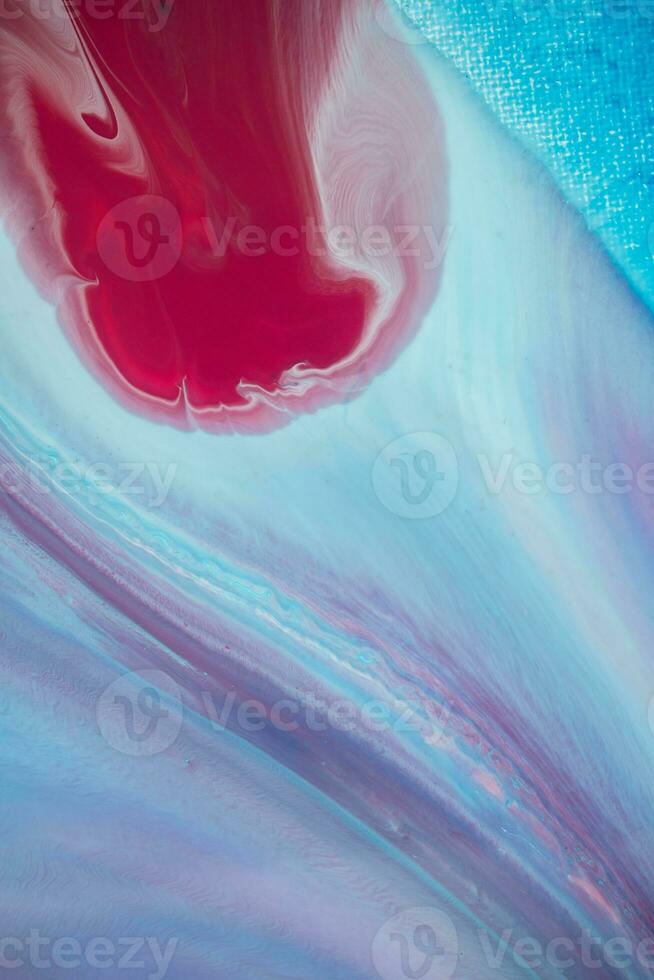 Abstract created using the technique of liquid acrylic. Macro photography of the smallest details of a panting. The panting shows how overflows of shades and colors of paint resemble space motifs. photo