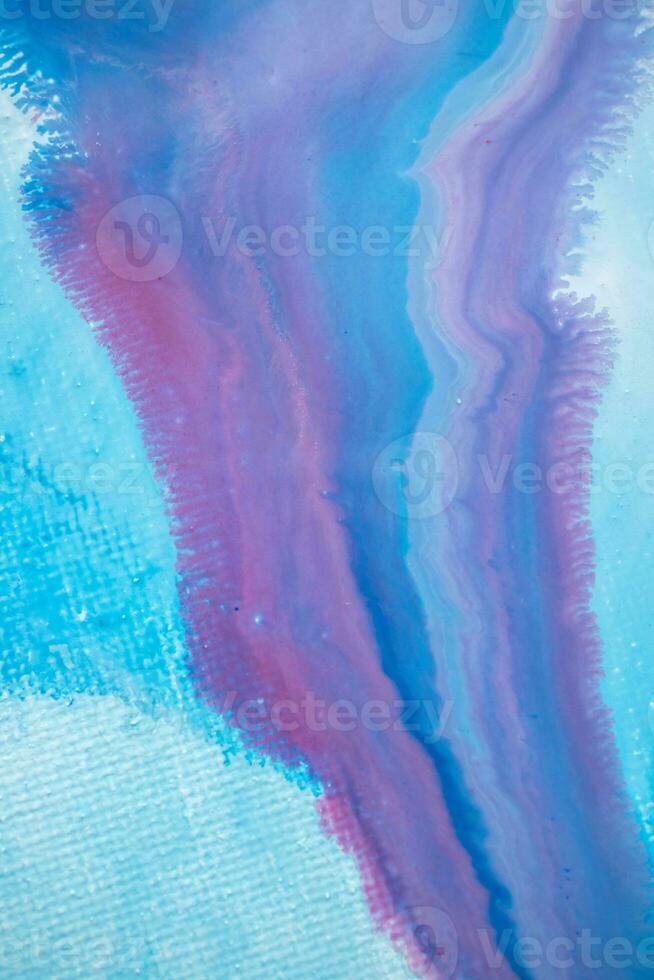 Abstract created using the technique of liquid acrylic. Macro photography of the smallest details of a panting. The panting shows how overflows of shades and colors of paint resemble space motifs. photo