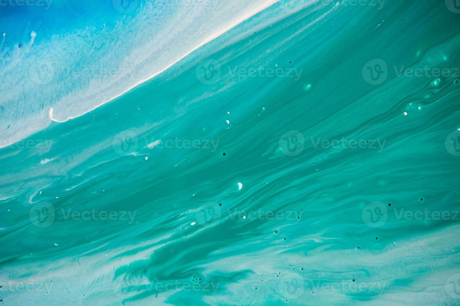 Abstract created using the technique of liquid acrylic. Macro photography of the smallest details of a panting. The panting shows how overflows of shades and colors of paint resemble space motifs. photo